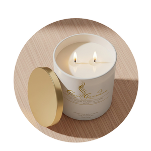 White candle in a decorative container with a gold lid on a wooden surface