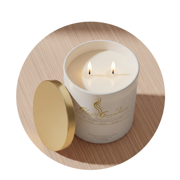White candle in a decorative container with a gold lid on a wooden surface