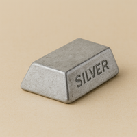 Silver ingot on a beige background